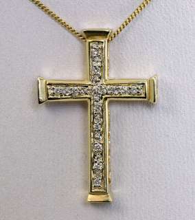  and 14k yellow gold traditional style cross pendant measuring 1
