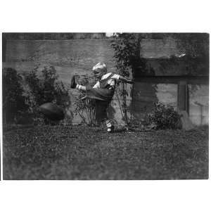  A high kick,Small boy kicking football,May 23,c1916,Child 